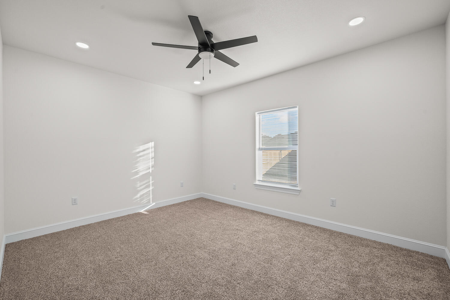 6923 17th Street Lubbock, TX 79416 - Photo 19 of 34 an empty room with a window and a ceiling fan