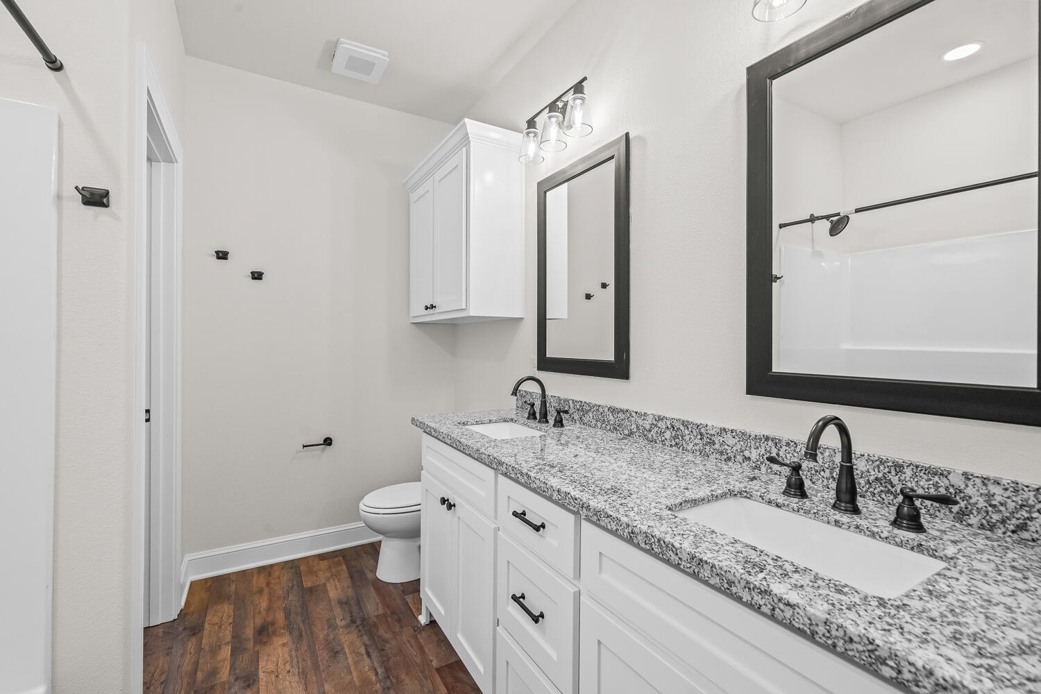 6923 17th Street Lubbock, TX 79416 - Photo 22 of 34 a bathroom with a granite countertop sink double vanity and a mirror