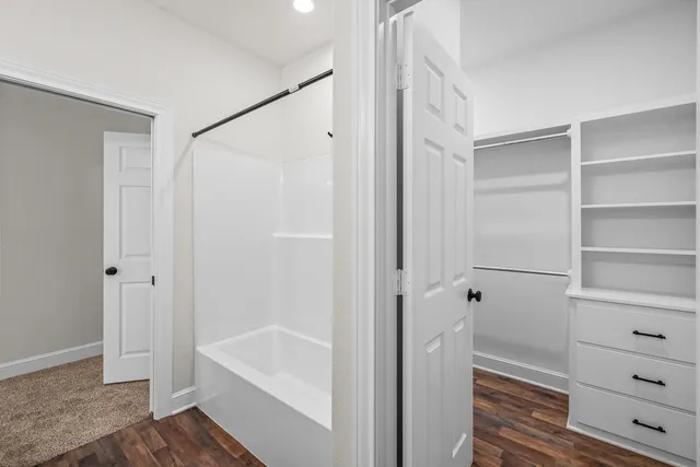 a bathroom with a bathtub and a shower