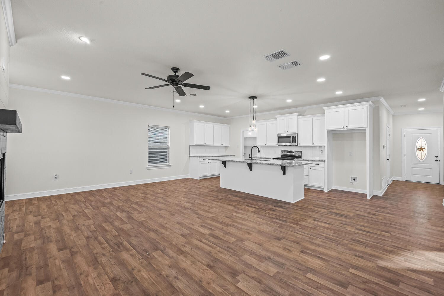 6923 17th Street Lubbock, TX 79416 - Photo 9 of 34 a view of kitchen with kitchen island white cabinets and refrigerator