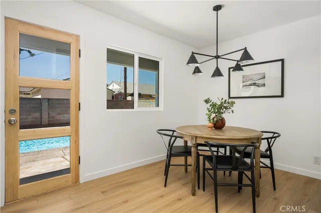 a view of a dining room with a table and chairs