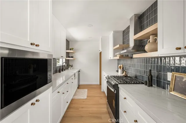 a kitchen with stove and cabinets