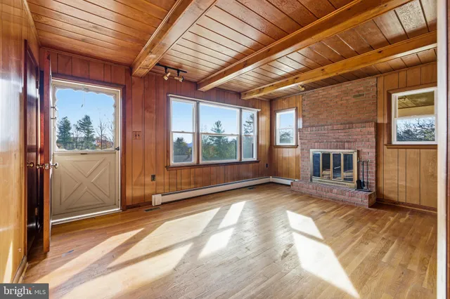a view of an empty room with wooden floor
