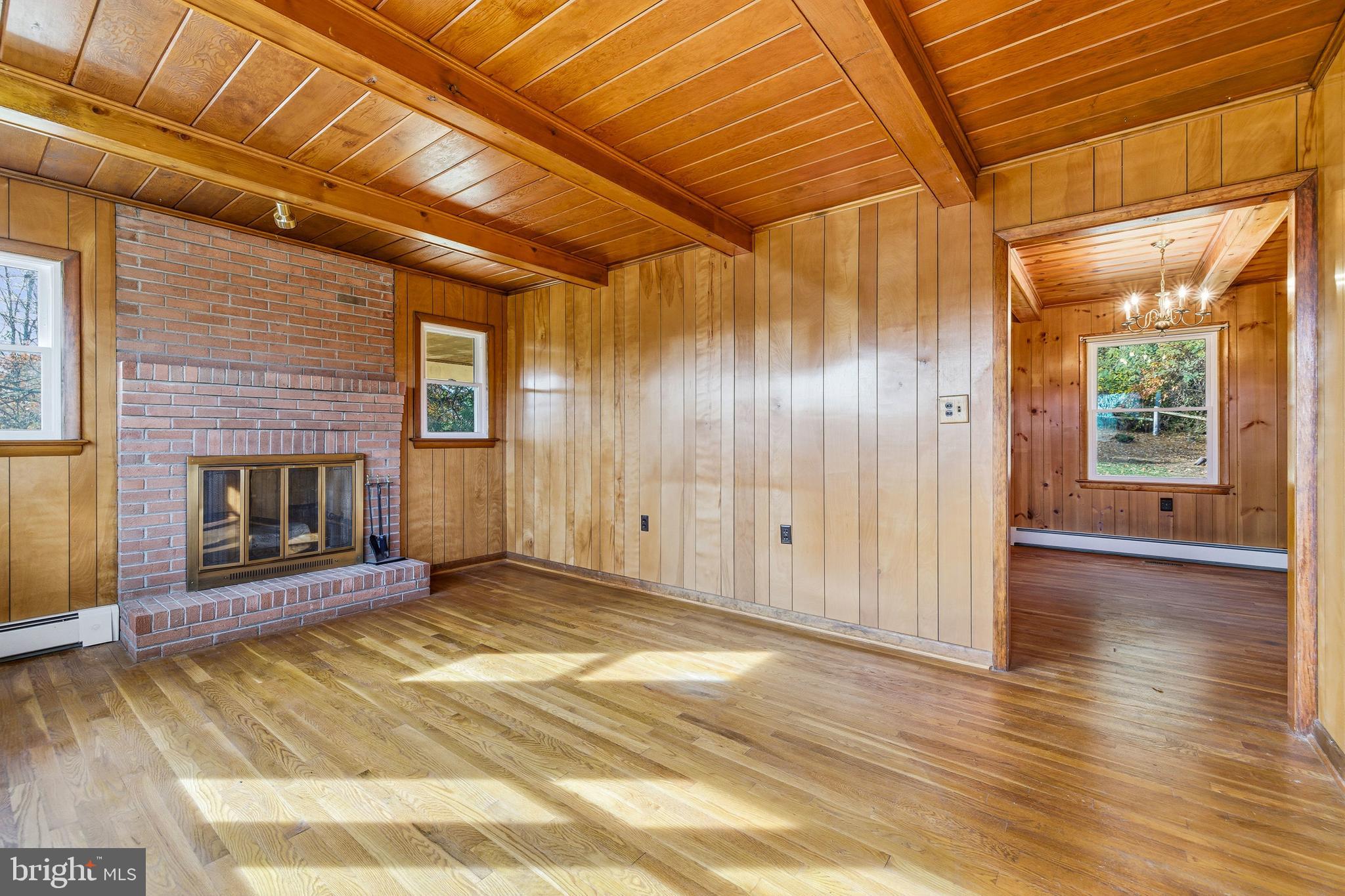 27 Atkins Road Sperryville, VA 22740 - Photo 17 of 76 a view of a livingroom with wooden floor and a fireplace