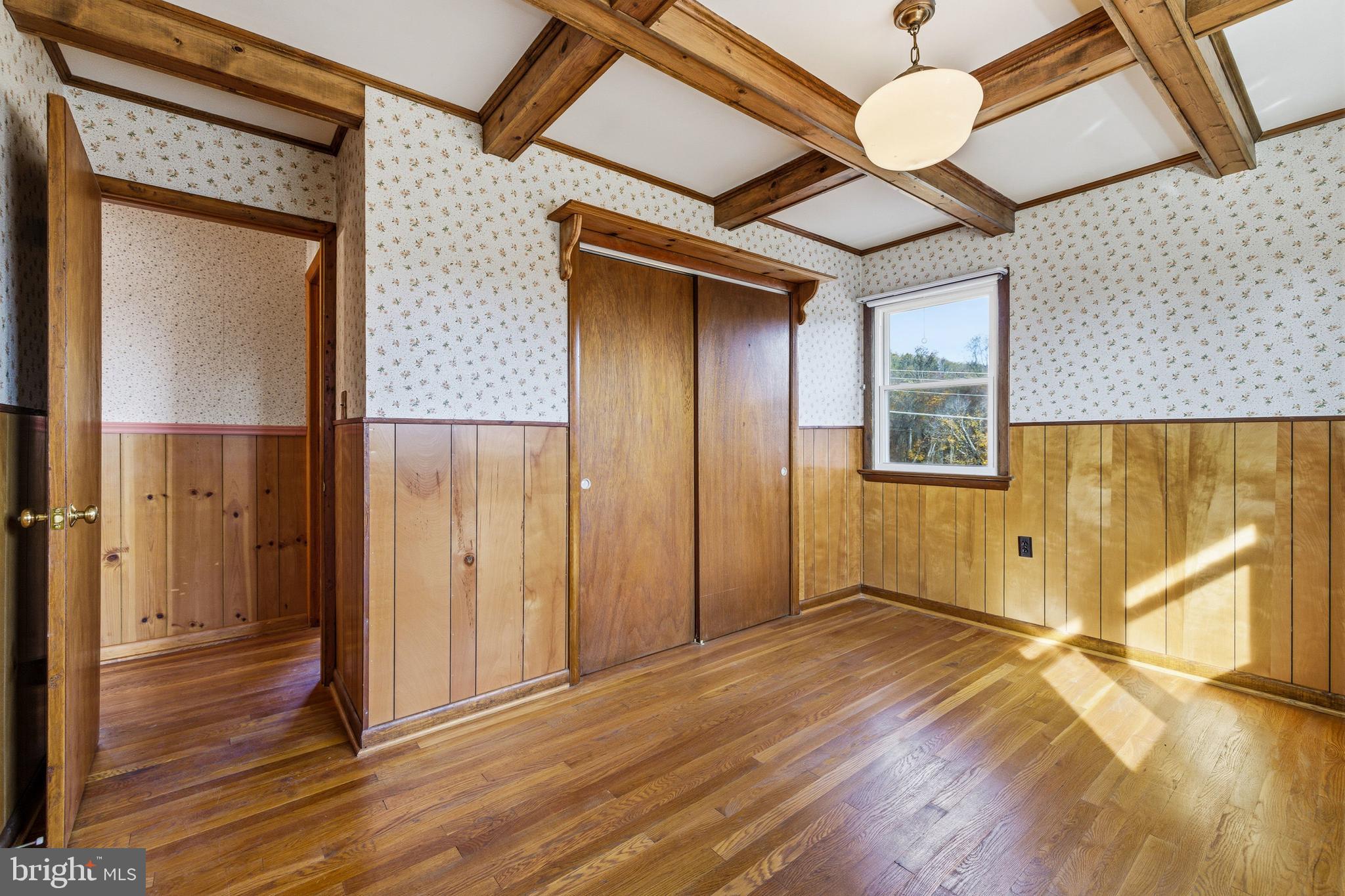 27 Atkins Road Sperryville, VA 22740 - Photo 28 of 76 an empty room with wooden floor a ceiling fan and windows