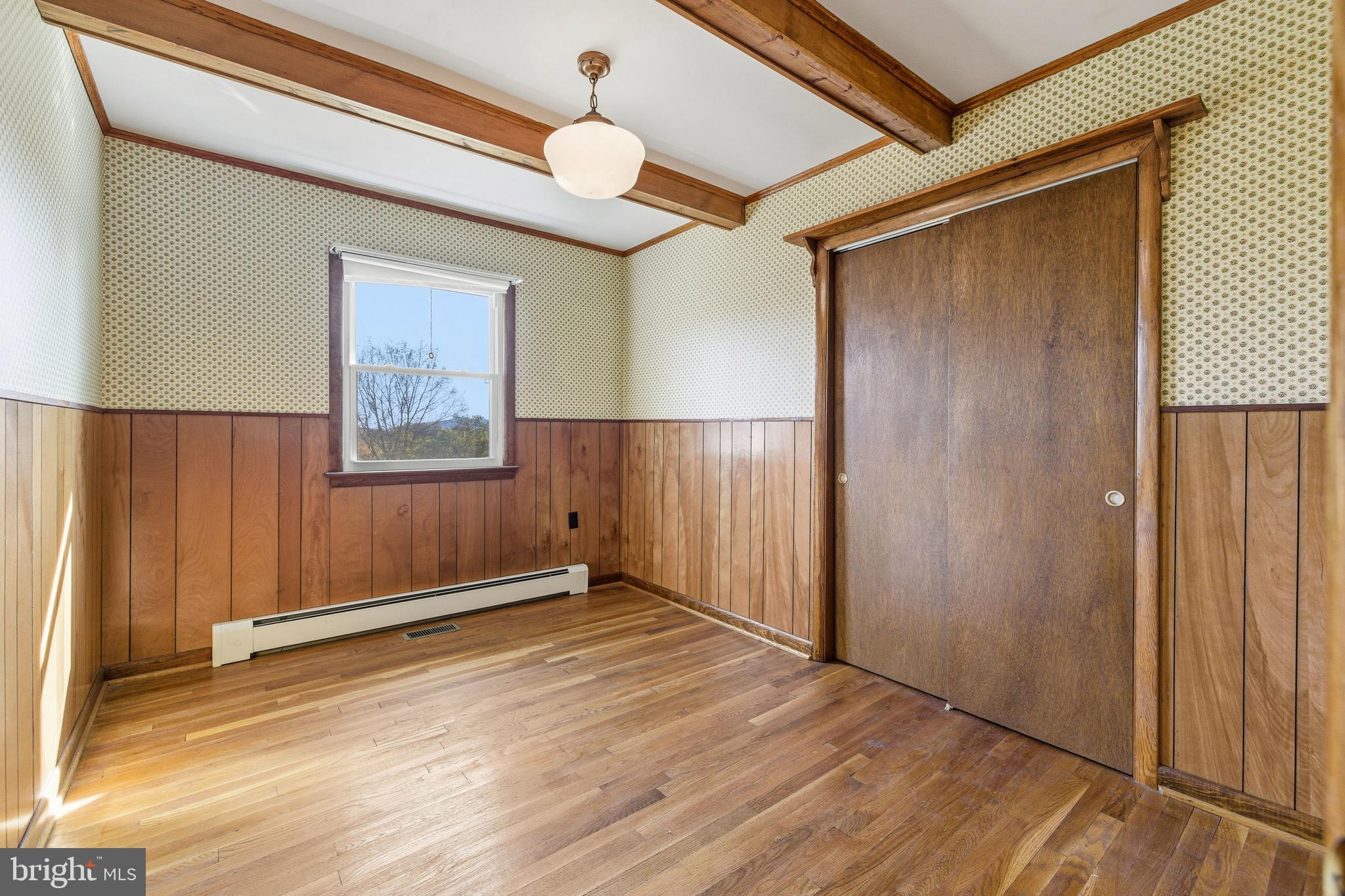 27 Atkins Road Sperryville, VA 22740 - Photo 30 of 76 a view of an empty room with wooden floor and a window