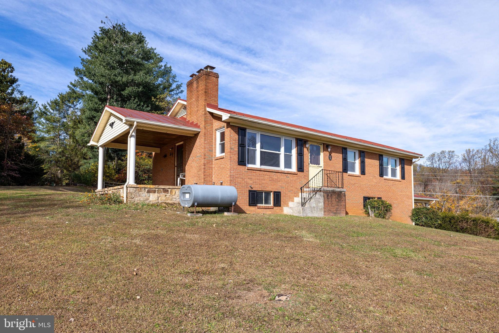 27 Atkins Road Sperryville, VA 22740 - Photo 44 of 76 a front view of a house with a yard