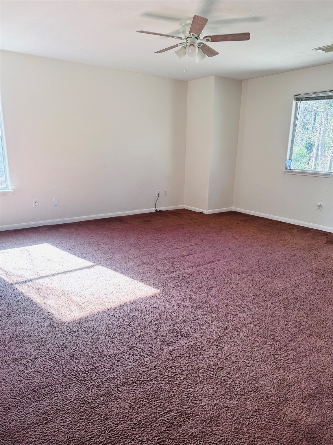 13215 Crim Road Houston, TX 77049 - Photo 13 of 20 an empty room with a ceiling fan and window
