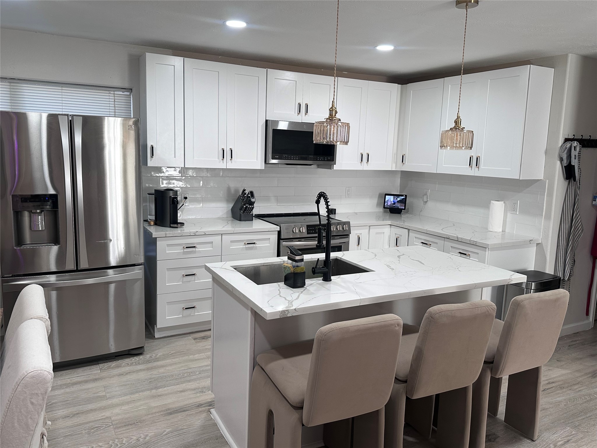 13215 Crim Road Houston, TX 77049 - Photo 6 of 20 a kitchen with stainless steel appliances granite countertop a sink a microwave a refrigerator and white cabinets