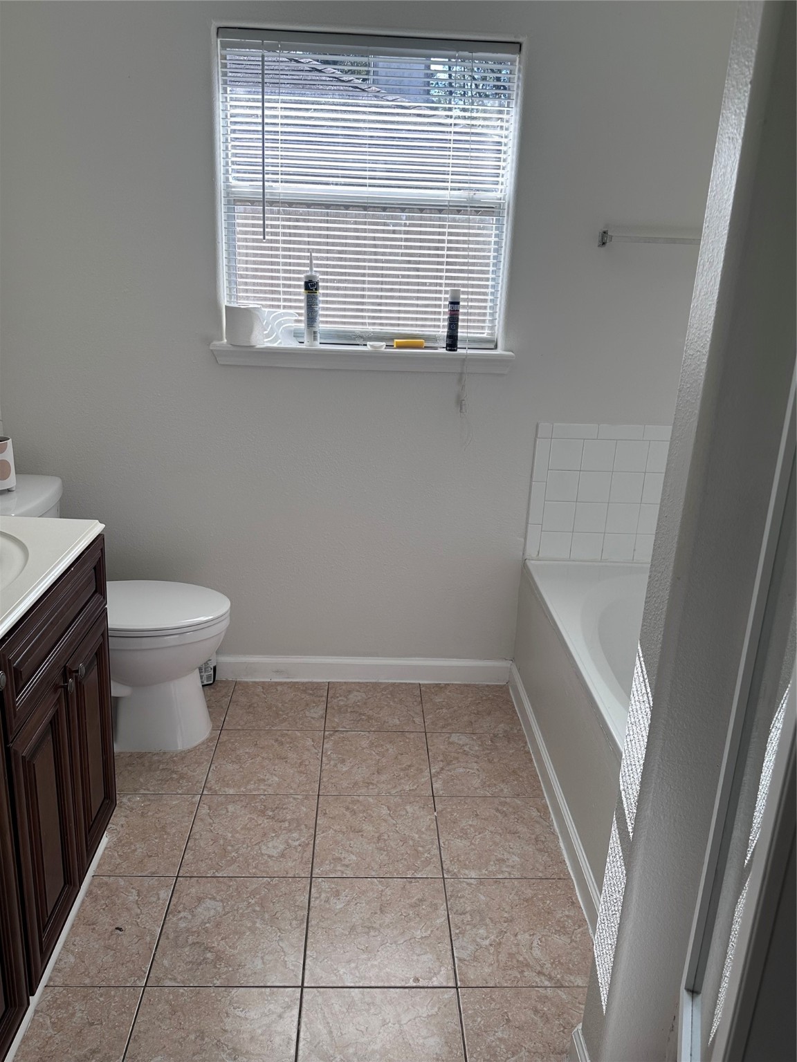 13215 Crim Road Houston, TX 77049 - Photo 10 of 20 a bathroom with a toilet a sink and a window