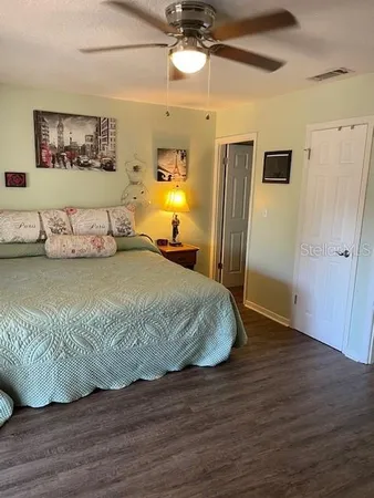 a bedroom with a bed and flat screen tv