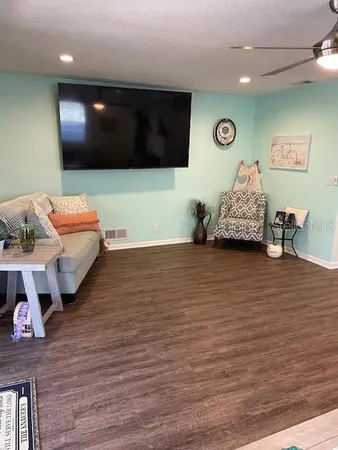 a living room with furniture wooden floor and a fireplace
