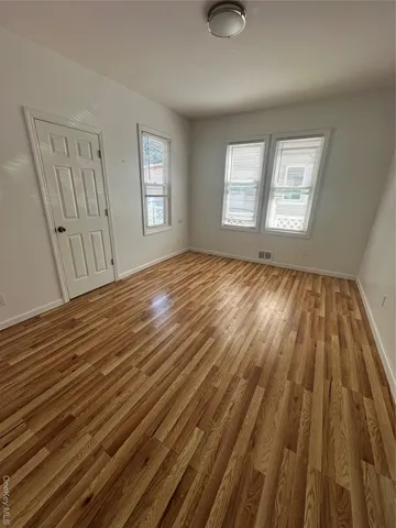 a view of wooden floor and windows in a room