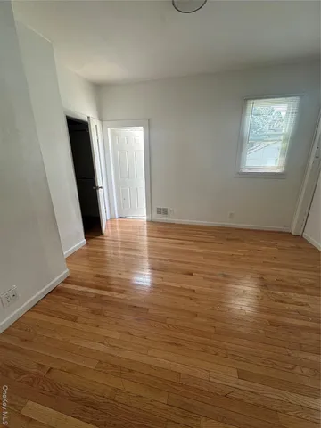 a view of an empty room and a window