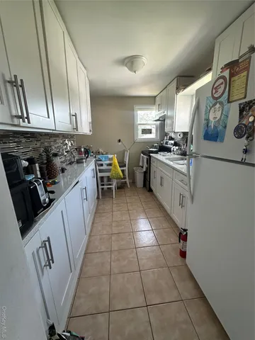 a kitchen with stainless steel appliances a sink stove top oven and cabinets