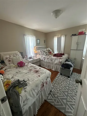 a bedroom with two beds and a window