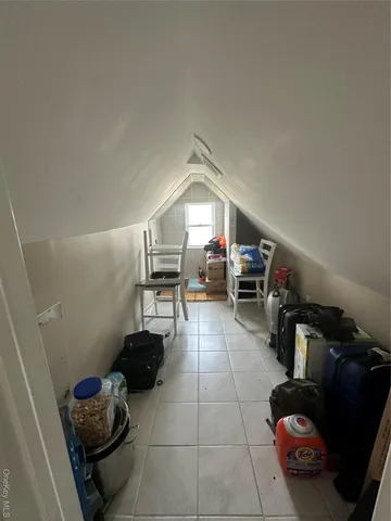 a living room with furniture and a book shelf