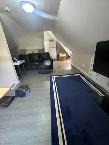 a living room with chairs and stairs