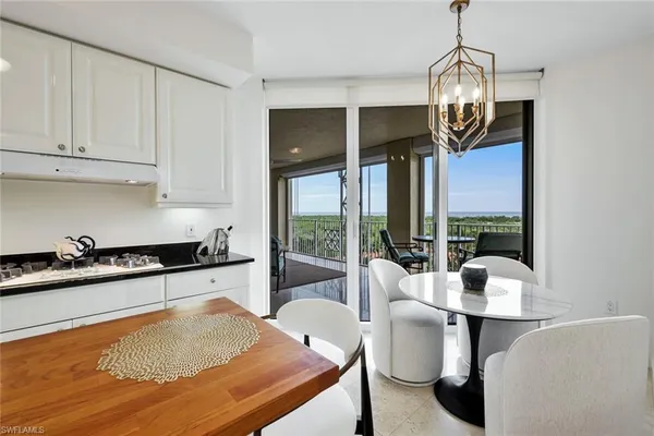 a kitchen with stainless steel appliances granite countertop a stove and white cabinets