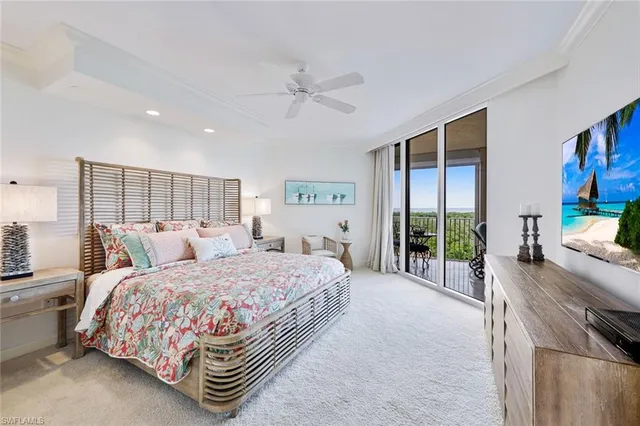 a bedroom with a bed and a large window with outer view