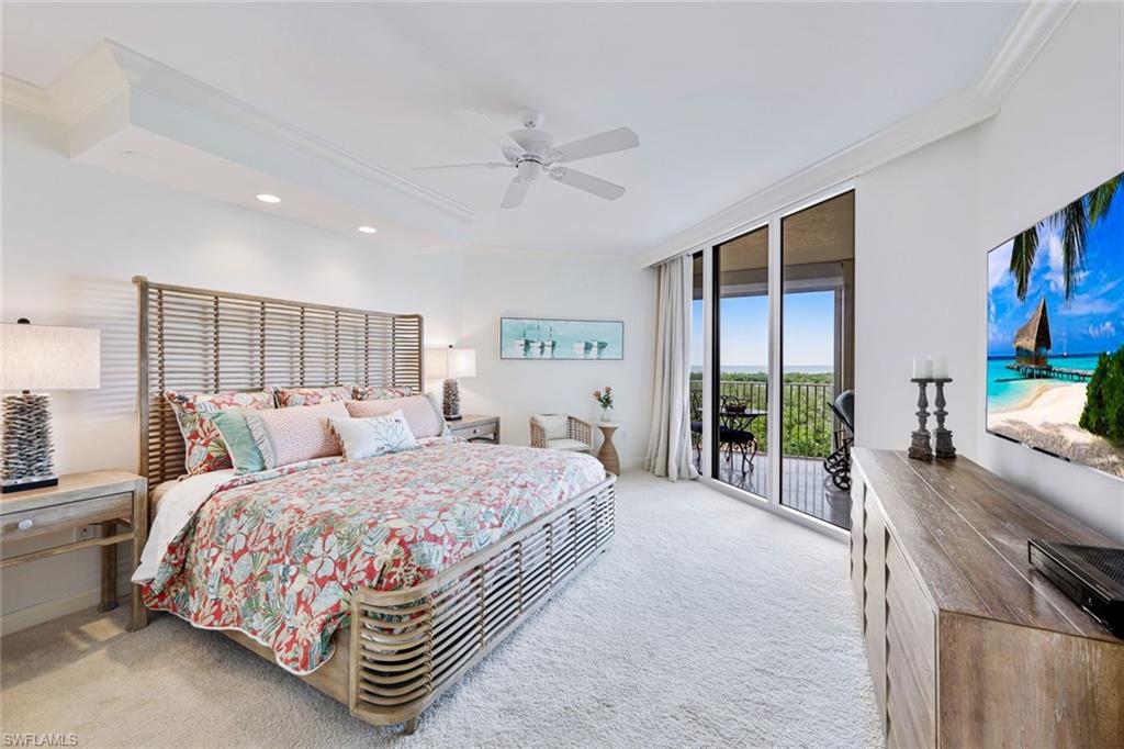 6597 Nicholas Boulevard, Unit 705 Naples, FL 34108 - Photo 17 of 34 a bedroom with a bed and a large window with outer view