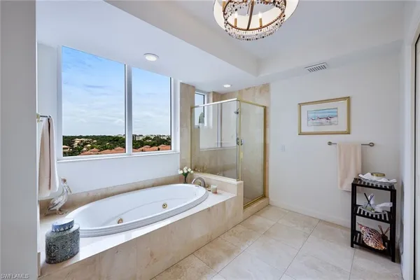 a bathroom with a tub a sink and a shower