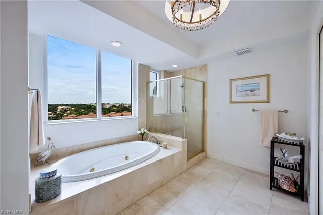 a bathroom with a tub a sink and a shower