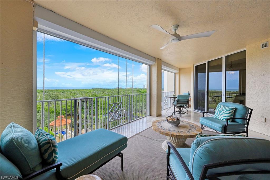 6597 Nicholas Boulevard, Unit 705 Naples, FL 34108 - Photo 26 of 34 a living room with furniture and a floor to ceiling window