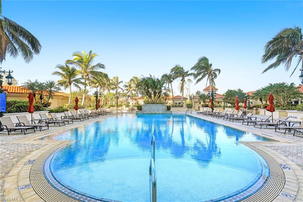 6597 Nicholas Boulevard, Unit 705 Naples, FL 34108 - Photo 31 of 34 a view of a swimming pool with outdoor seating