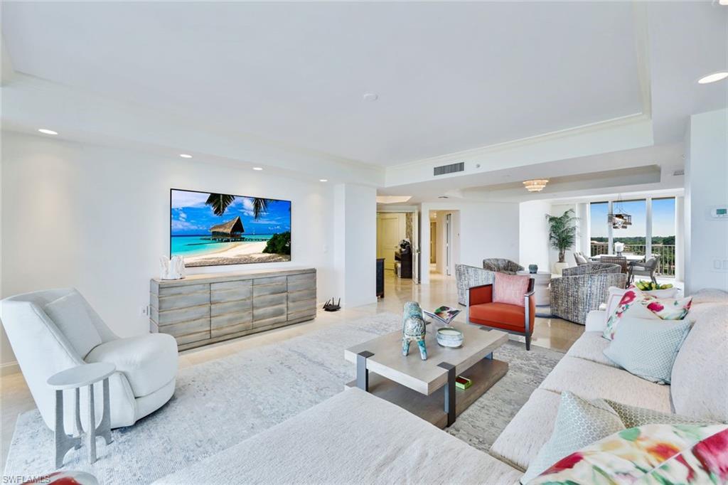 6597 Nicholas Boulevard, Unit 705 Naples, FL 34108 - Photo 8 of 34 a living room with furniture and a flat screen tv