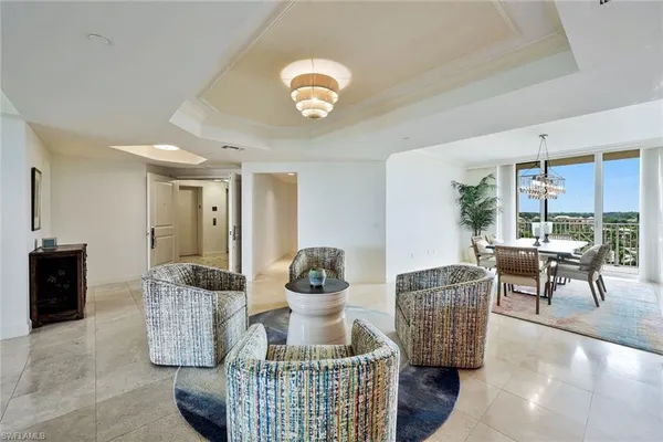 a living room with furniture and a chandelier