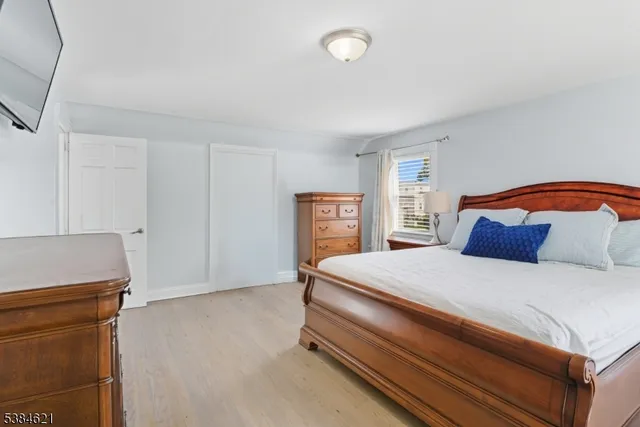 a bedroom with a bed and dresser