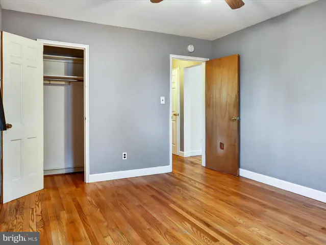 an empty room with wooden floor and a window