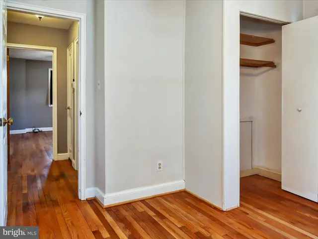 a view of walk in closet with empty room