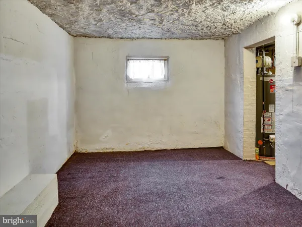 a bathroom with a sink a toilet a window and shower