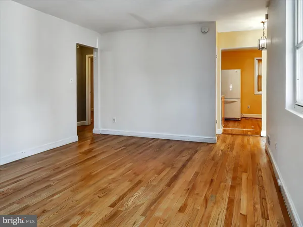 a view of a room with wooden floor and a sink
