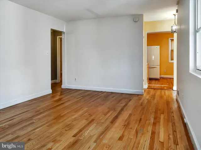 a view of a room with wooden floor and a sink