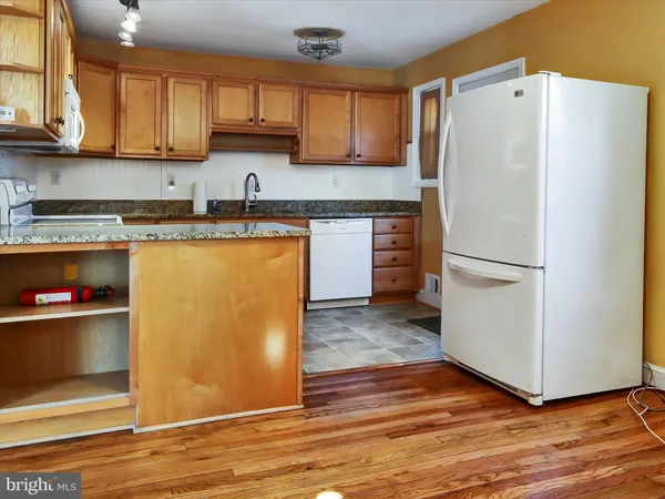 a kitchen with a refrigerator and a sink