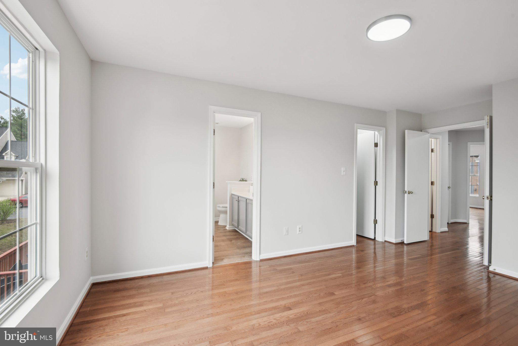 14206 Brenham Drive Centreville, VA 20121 - Photo 25 of 68 a view of an empty room with wooden floor and a window