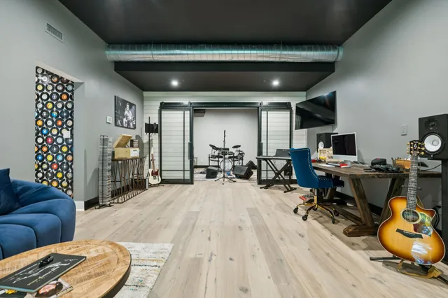 a living room with furniture a rug and a chandelier
