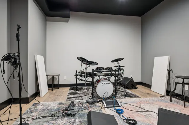 a bed sitting in a bedroom next to a window with wooden floor