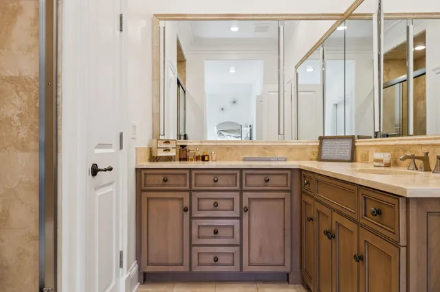 a spacious bedroom with a large bed and a chandelier