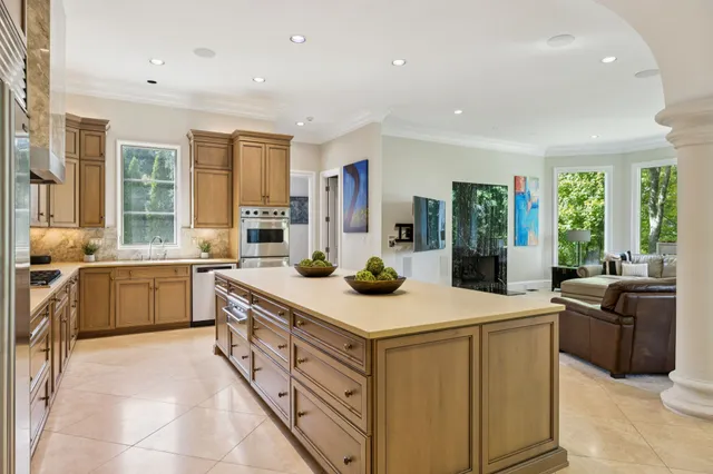 a kitchen with granite countertop cabinets stainless steel appliances and a counter space