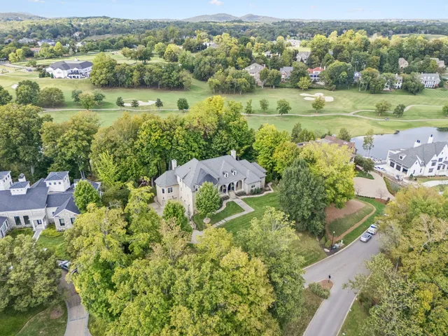 an aerial view of a house with yard