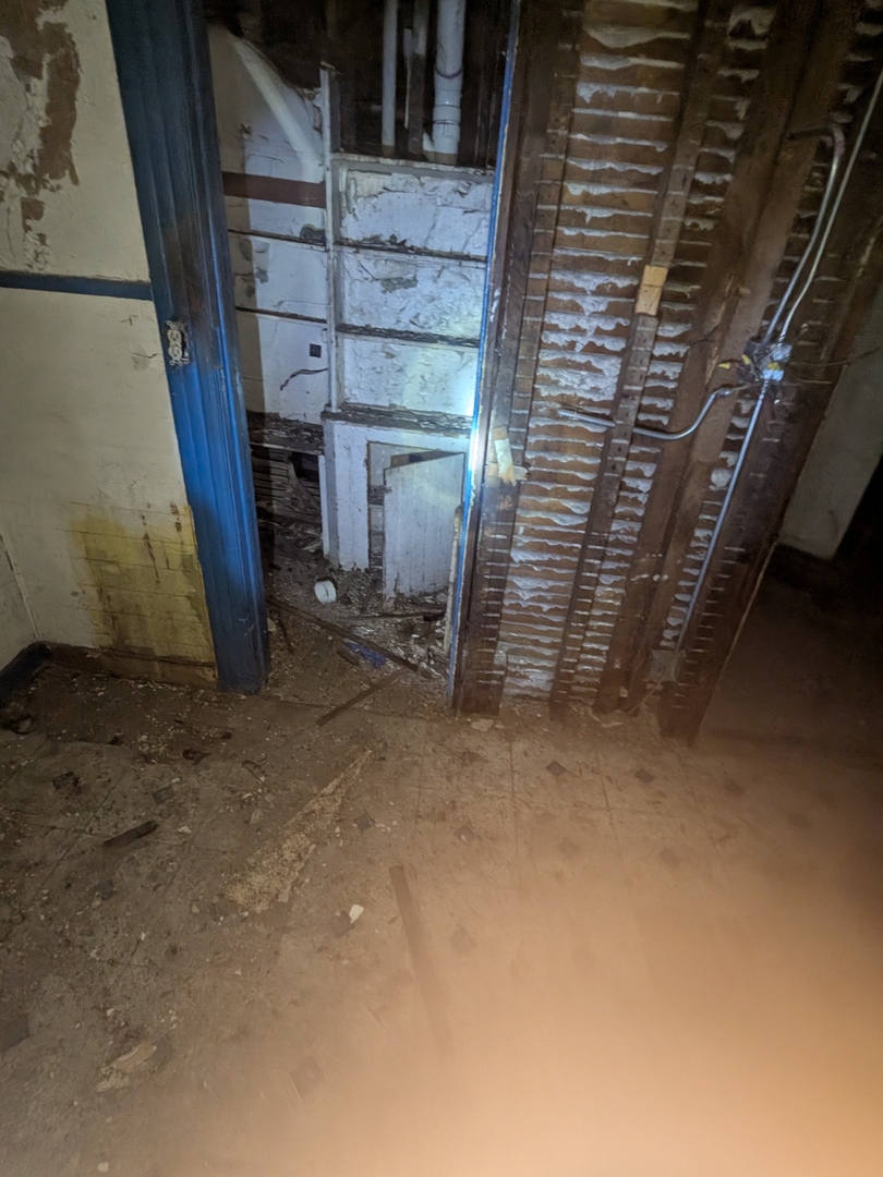 7732 South Normal Avenue Chicago, IL 60620 - Photo 21 of 29 a view of an empty room with wooden stairs and stairs