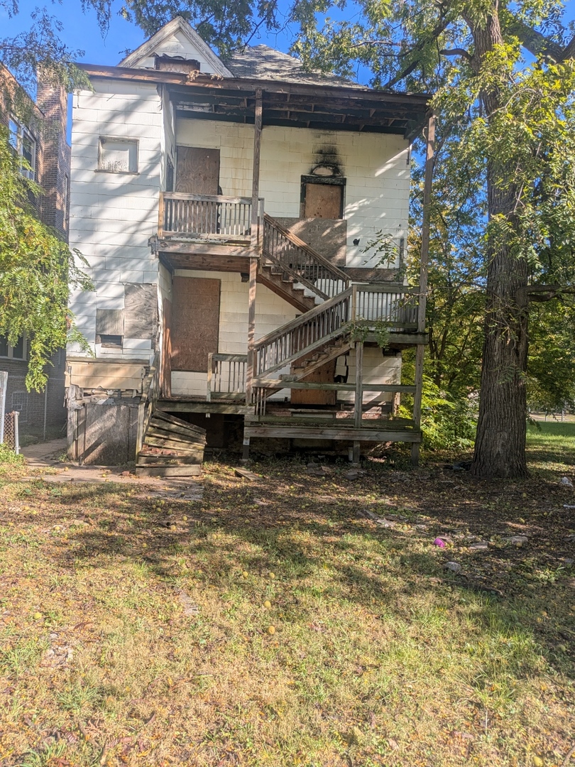 7732 South Normal Avenue Chicago, IL 60620 - Photo 4 of 29 a view of a house with a yard
