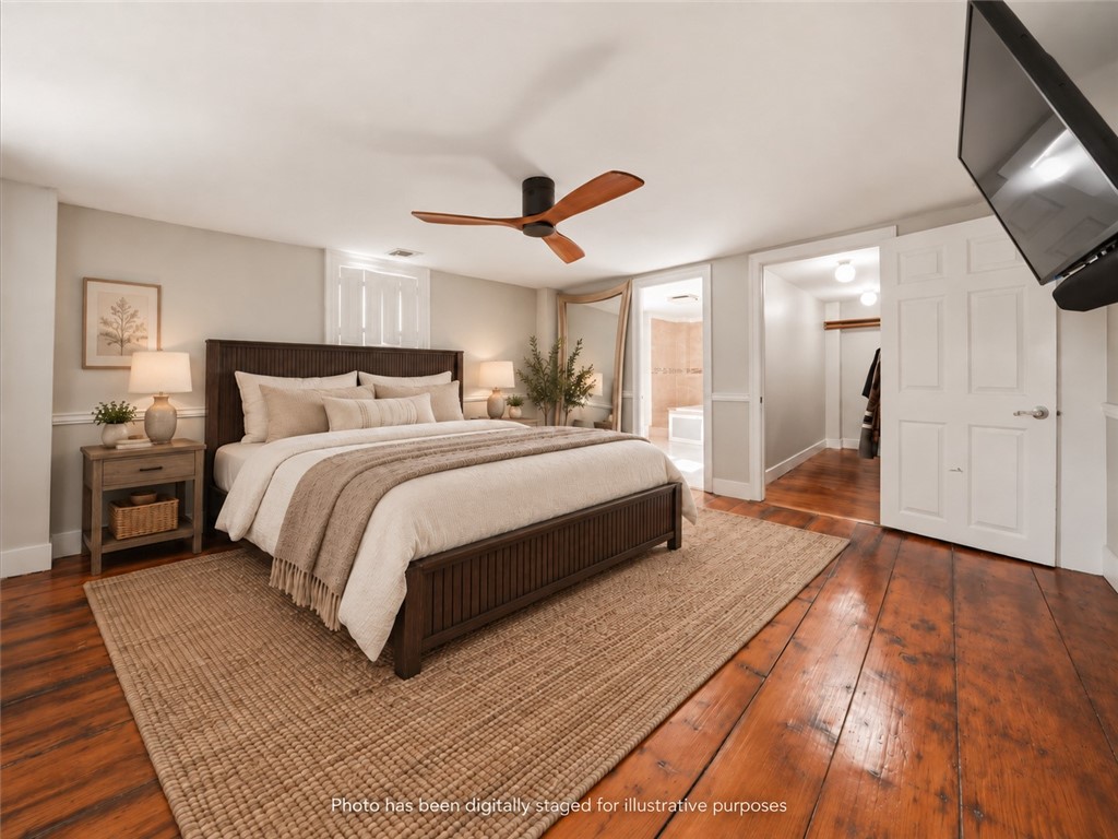 32 Equestrian Way Cranston, RI 02921 - Photo 22 of 48 The primary bedroom offers an impressive private sanctuary on the second floor, complete with beautifully aged wide-plank flooring, its own fireplace, a substantial walk-in closet and a bright ensuite bath. The result is a suite that feels both timeless and highly functional.