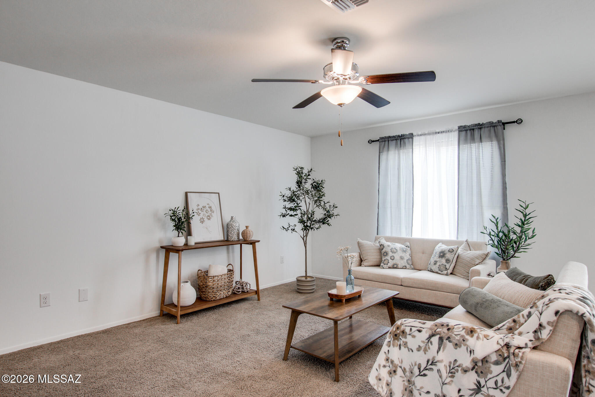 5987 South Antrim Loop Tucson, AZ 85706 - Photo 8 of 34 a living room with furniture and a chandelier