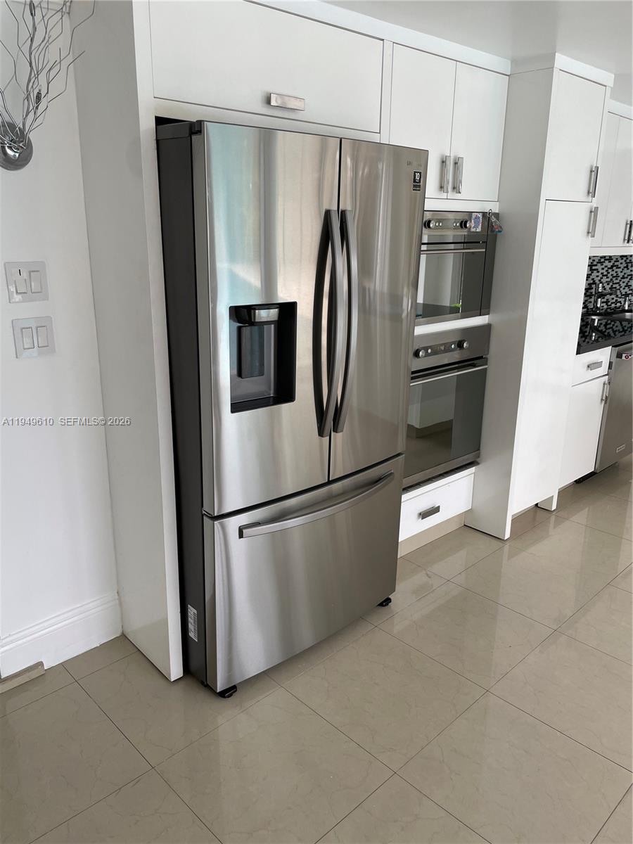 5321 Southwest 89th Court Miami, FL 33165 - Photo 1 of 4 a metallic refrigerator freezer sitting in a kitchen