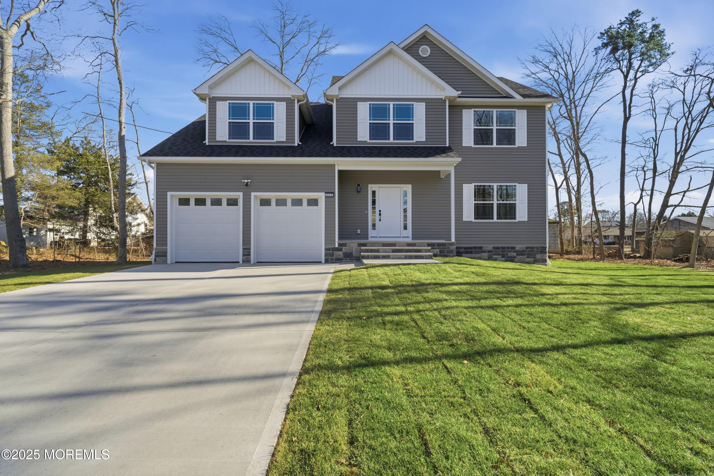 a front view of house with yard and green space